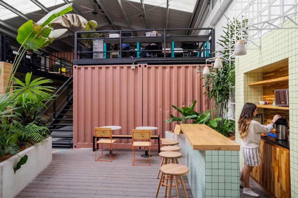 NOI Coworking interior with modern desks and green plants in El Poblado